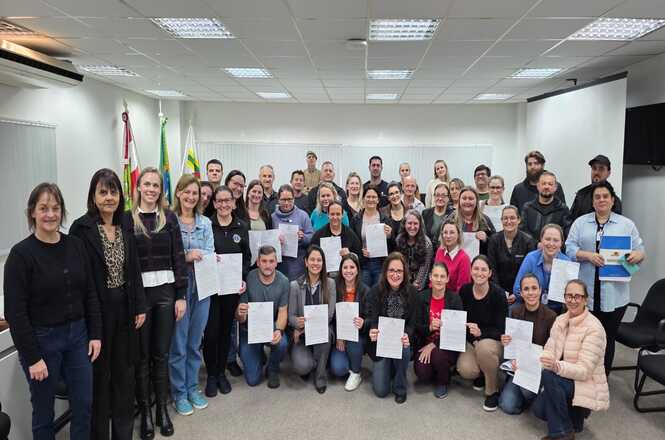 Foto horizontal: participantes posam para foto coletiva após cerimônia de entrega de certificados na comarca de Maravilha.