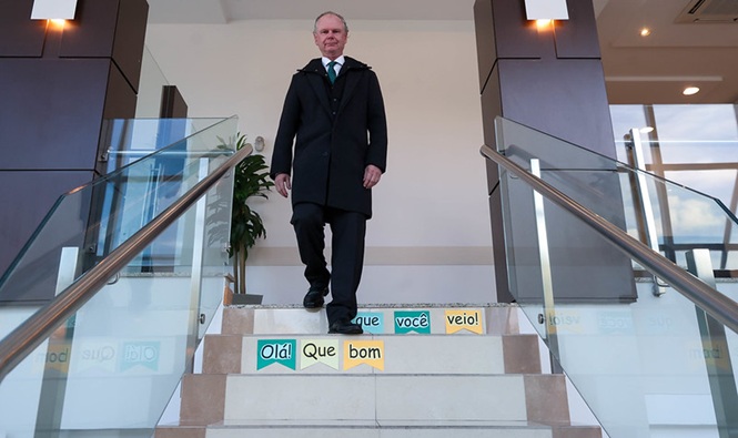 Foto horizontal: o presidente do TJSC, desembargador Rubens Schulz, desce escadaria decorada com mensagens de boas-vindas durante visita ao Programa de Preparação para Aposentadoria (PPA).