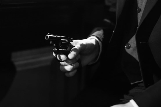 Homem segurando arma.