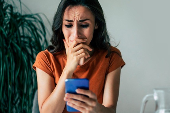 Mulher segurando celular.