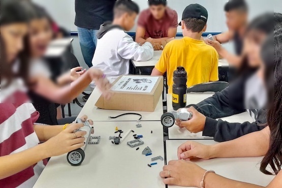 Adolescentes na oficina de robótica.