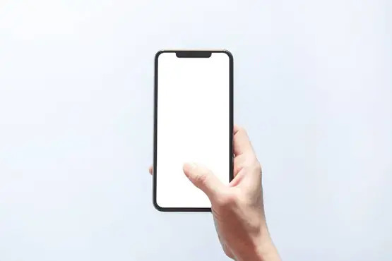 Mão segurando um celular com tela em branco.