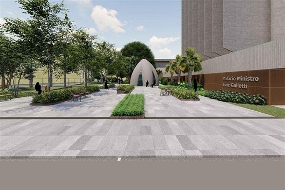 A imagem mostra um projeto de uma área externa. Ela possui um caminho pavimentado de pedras claras, cercado por áreas verdes e árvores. No centro, ao fundo, há uma estrutura em formato de cúpula, que parece ser uma entrada ou um monumento. À direita, há um edifício grande com uma parede onde está escrito "Palácio Ministro Luiz Gallotti". Alguns bonecos estão caminhando ou paradas ao longo do caminho. O céu está claro com algumas nuvens. A cena transmite uma sensação de tranquilidade e organização urbana.